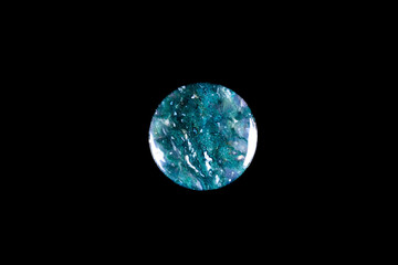 green moss agate (chalcedony crystal with green dendritic inclusion) macro detail black isolated background. close-up polished semi-precious gemstone copy space