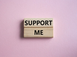 Support me symbol. Wooden blocks with words Support me. Beautiful pink background. Business and Support me concept. Copy space.