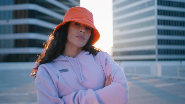 Cool fashionable black mixed race woman vlogger listening music dance track from 90s. Trendy black girl dances, recording videostream video for tiktok at city street. Creating dancing social media app