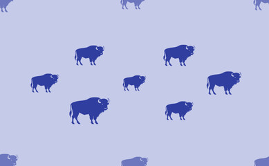 Seamless pattern of large isolated blue buffalo symbols. The pattern is divided by a line of elements of lighter tones. Vector illustration on light blue background