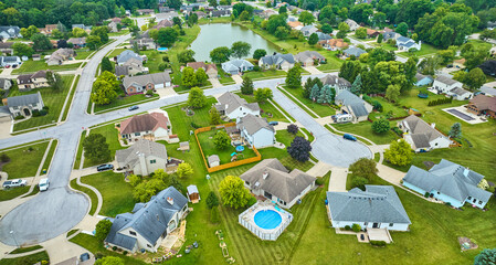 Aerial over neighborhood with variety of homes and houses with fences and pools and trees - obrazy, fototapety, plakaty