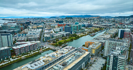 Aerial Mission Bay with city buildings and distant mountainous skyline