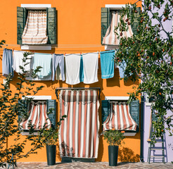 colorful house facade with clothing drying in Burano Venice