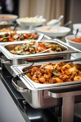 a luxury buffet of vegetarian dishes in a restaurant, stainless steel buffet ware with lid, white tables