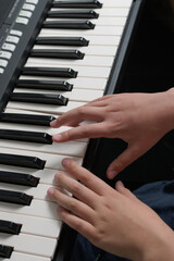 Piano music lessons. two hands playing chords and scales exercizes. Synthesizer keyboard close-up.