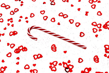 Red and white candy canes lie on a white background with confetti.