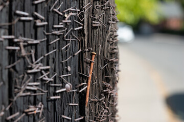 a utility pole exhibiting corrosion due to the presence of oxidized fasteners