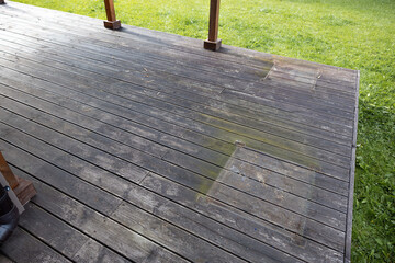 Weathered wooden deck, terrace with algae and moss, spring cleaning in garden and yard - obrazy, fototapety, plakaty