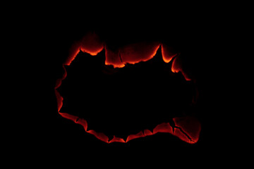 burning paper, glowing edge of paper on a black background