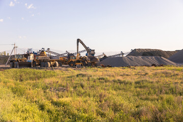 Fototapeta premium Heavy equipment works at a sand processing quarry