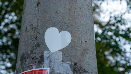 concrete utility pole and grungy white sticker heart