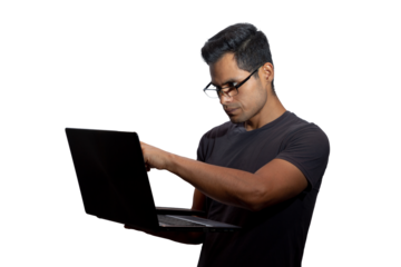 Young Latino with glasses and a laptop, looking at and pointing to the computer screen. Networking concept, programming, business, cybersecurity. Isolated.