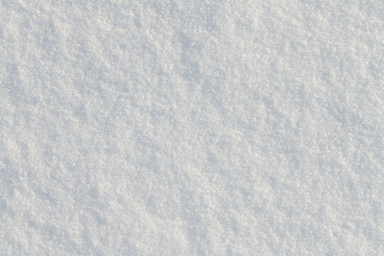 Background and texture of freshly fallen snow. The image is white. The snow is photographed from above.