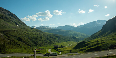 Caravan scaling winding road, free in the mountain alps