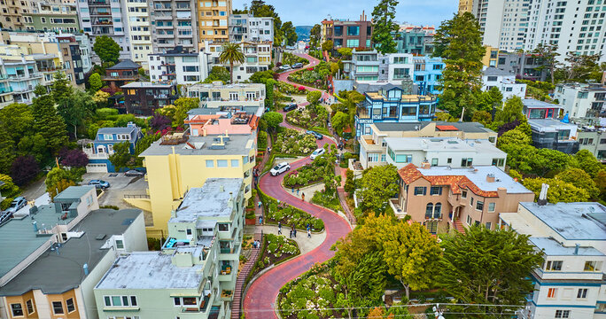 Gorgeous wider aerial of iconic Lombard Street with buildings on either side of red brick road