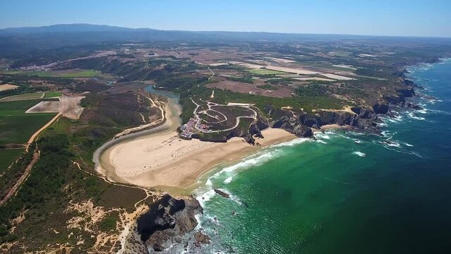 Aerial video filming by drone of sea bay and beach near village of Odeceixe Alentejo Portugal. Bird's eye view of the Alentejo region