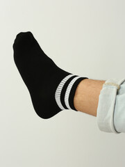 black and white socks with copy space on human feet closeup photo on white background