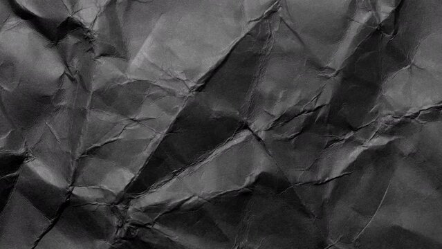 Crumpled rough dark surface. Seamless loop background.