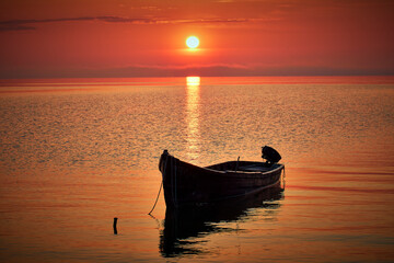 sunrise with boats on the lake