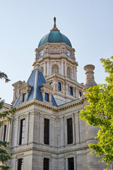 Clock tower on tall Whitley County Courthouse with castle like architecture