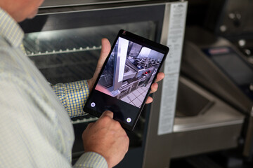 Chef Capturing a Photo with iPad in Commercial Kitchen