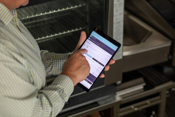 Chef Using iPad in Commercial Kitchen for Audit