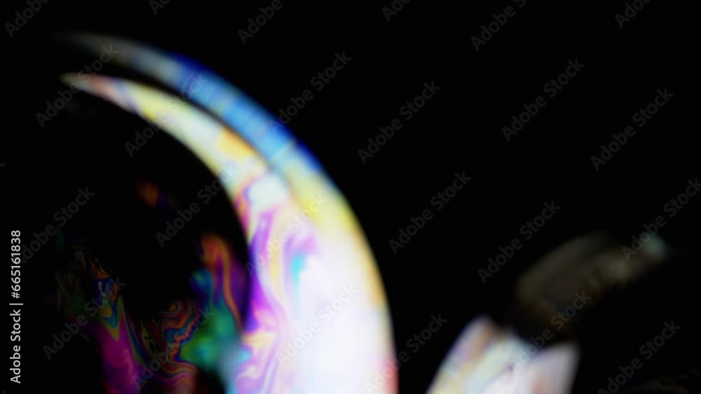 Poster two large colorful soap bubbles fly on a black background in empty space. close up. vibrating transp
