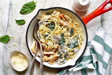 Spaghetti pasta with chicken, spinach and mushrooms. Top view with copy space.