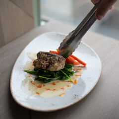 Sous Vide Pan-Seared Chicken Breast Over Spinach, Carrots, and Sauce