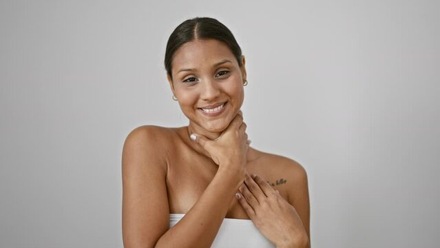 Young latin woman smiling confident massaging neck over isolated white background
