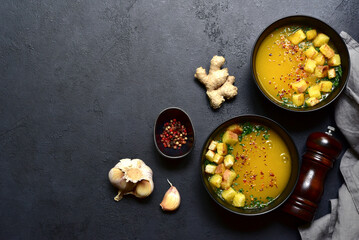 Hot spicy pumpkin soup with ginger and garlic. Top view with copy space.