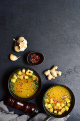 Hot spicy pumpkin soup with ginger and garlic. Top view with copy space.
