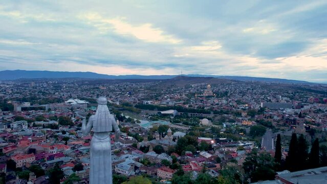 4k aerial tbilisi city footage just before sunrise with city lights and blue clouds in the sky