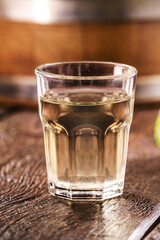 Cachaça, pinga, cana or caninha is the sugar cane brandy, a typical drink from Brazil, with a crackling appetizer in the background