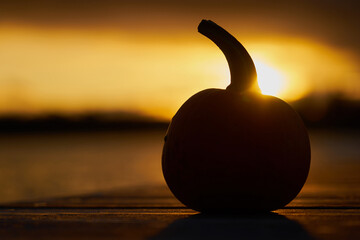 Silhouette of pumpkin on sunset. Halloween mood.