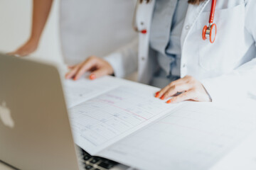 Fototapeta premium An experienced doctors examines an elderly patient, discussing and analyzing medical results.