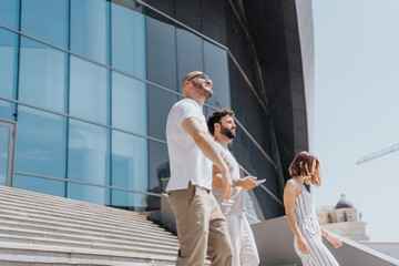 A diverse group of professionals collaborate outdoors, discussing strategies and reviewing reports for their business success.