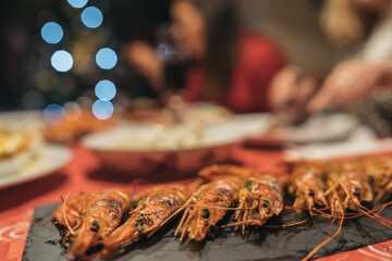 Close-up of a slate tray with grilled shrimp. Christmas dinner with the family.