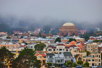 Misty fog over Palace of Fine Arts open air rotunda with wide view of city