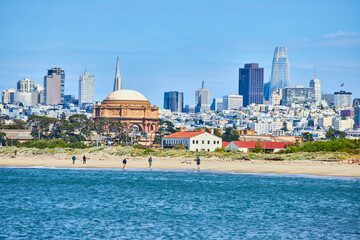 San Francisco Bay with people on beach and Palace of Fine Arts rotunda behind with skyscrapers