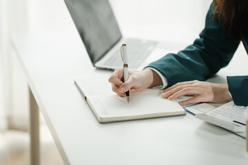 Financial institution worker female asian people, professionals engrossed in tasks. Business people diligently crunching numbers, advising clients, and securing deals from their desks.