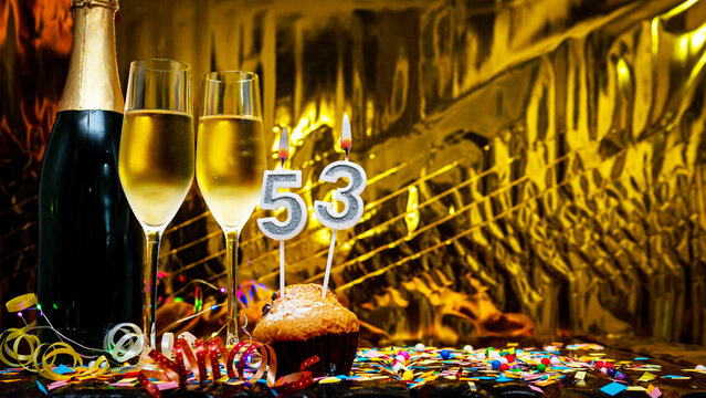 Copy space solemn background. Happy birthday golden background with number  53. Greeting card or postcard with a bottle of champagne with poured champagne in glasses.
