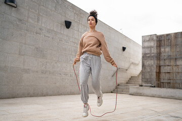 one woman young adult caucasian female with jumping rope training - Powered by Adobe