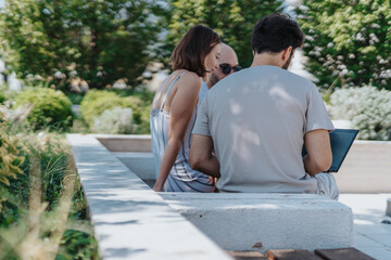 Analyzing statistics, discussing strategy, and setting new goals - a confident and professional small team collaborating and networking outdoors in the downtown area.