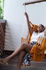 Woman relaxing in a hammock at home