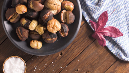 Fototapeta na wymiar Roasted chestnuts in cast iron pan