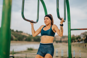 Fototapeta premium Fit Girl: Outdoor Workout on Horizontal Metal Bars