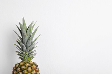 Fototapeta premium Whole ripe pineapple on white background. Space for text