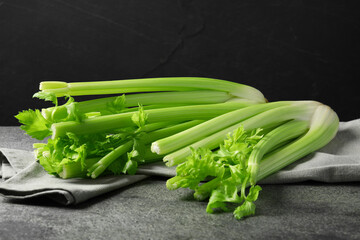 Fresh green celery bunches on grey table
