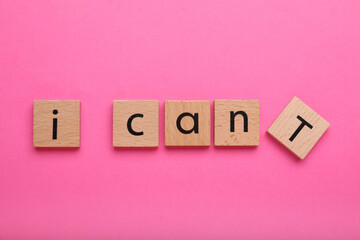 Motivation concept. Changing phrase from I Can't into I Can by removing wooden square with letter T...